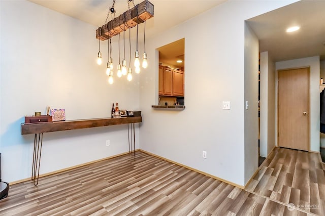 unfurnished dining area featuring light hardwood / wood-style floors