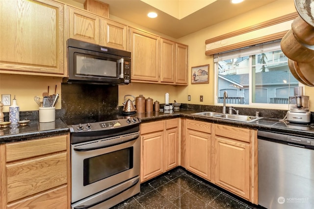 kitchen featuring light brown cabinetry, stainless steel appliances, and sink