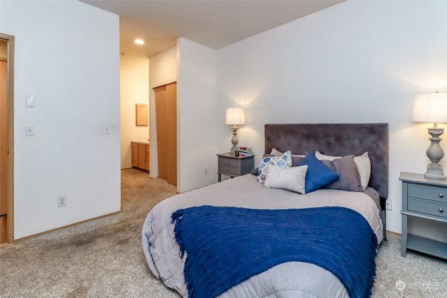 carpeted bedroom with ensuite bath