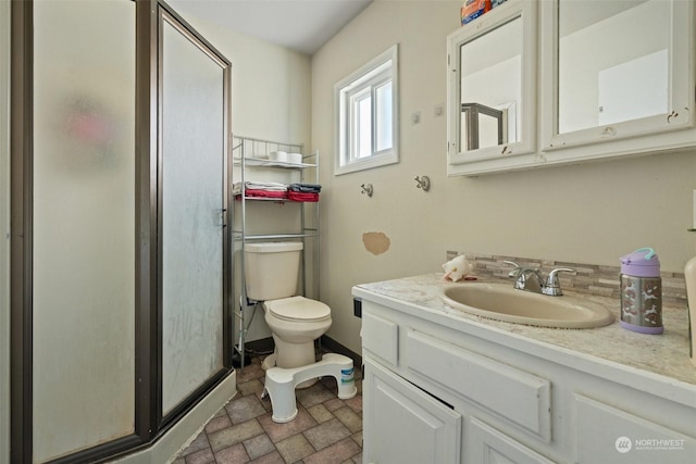 bathroom with vanity, toilet, and walk in shower