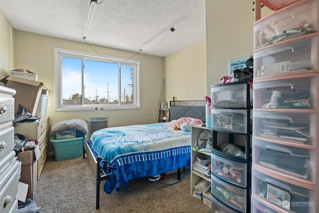 carpeted bedroom featuring a textured ceiling