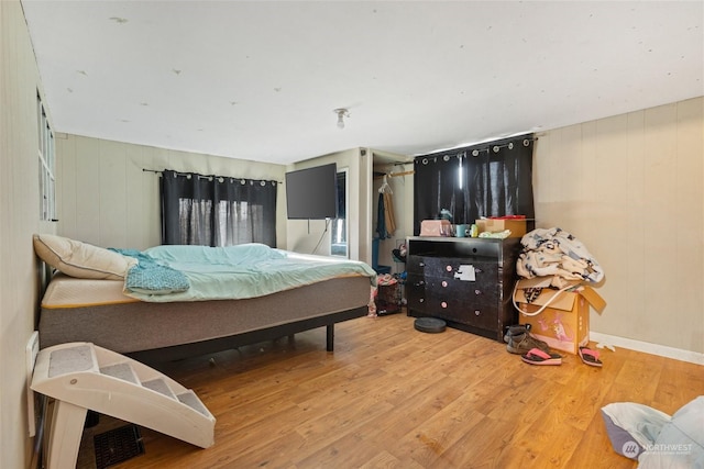 bedroom with hardwood / wood-style flooring