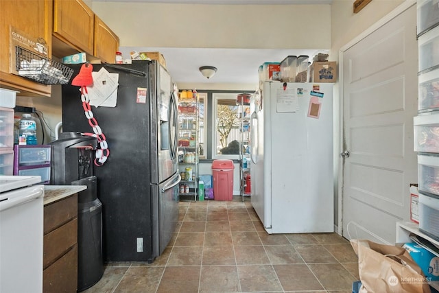 kitchen featuring stainless steel fridge and white refrigerator