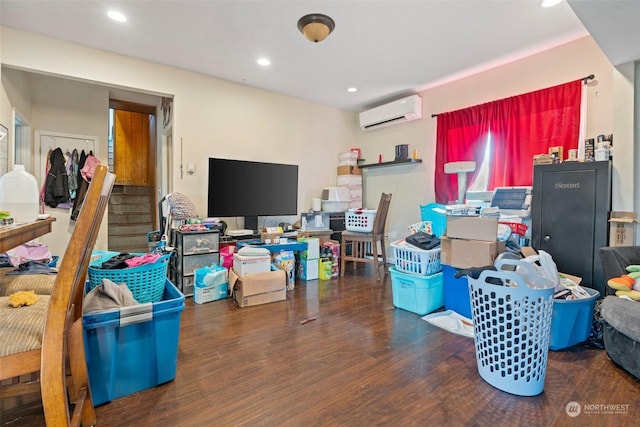 interior space with a wall mounted air conditioner and dark hardwood / wood-style flooring