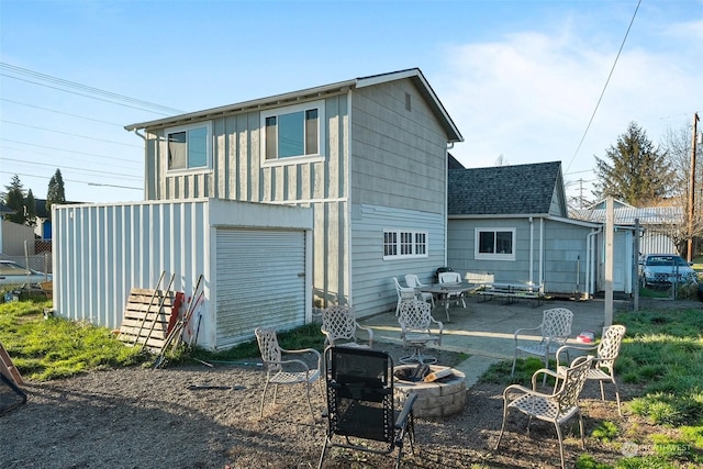 back of house with a garage and a patio area