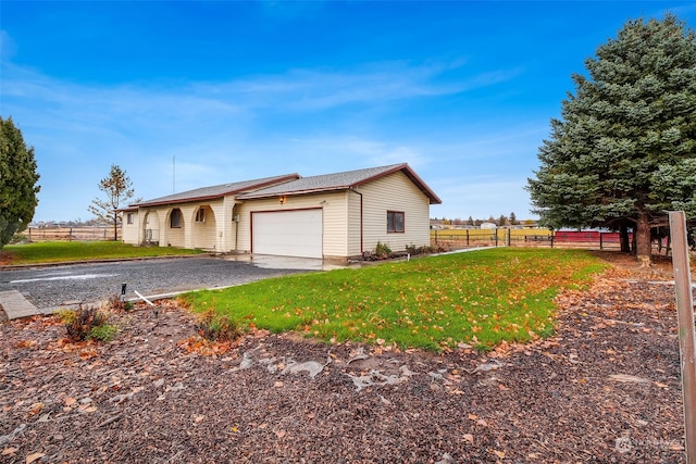 view of front of property featuring a garage and a front lawn