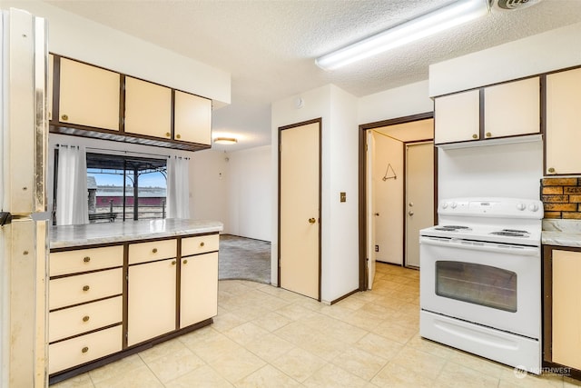 kitchen featuring a textured ceiling and electric stove