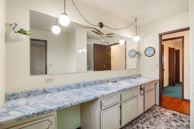 bathroom with vanity, hardwood / wood-style floors, and a textured ceiling