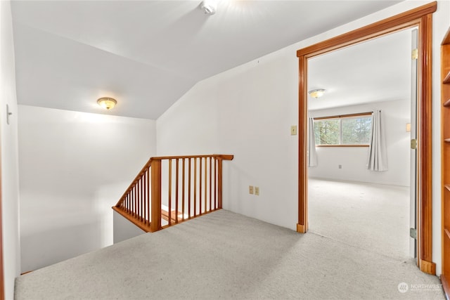 stairs featuring carpet floors and vaulted ceiling