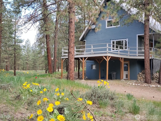 5 Chase Rd N, Winthrop, WA 98862 - back of house featuring a wooden deck, a carport, and dirt driveway