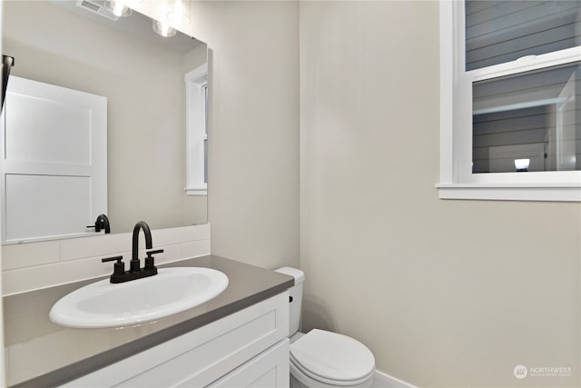 bathroom featuring vanity and toilet