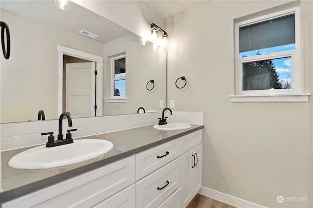 bathroom featuring hardwood / wood-style flooring and vanity