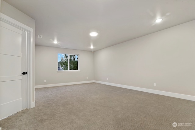 unfurnished room with light carpet