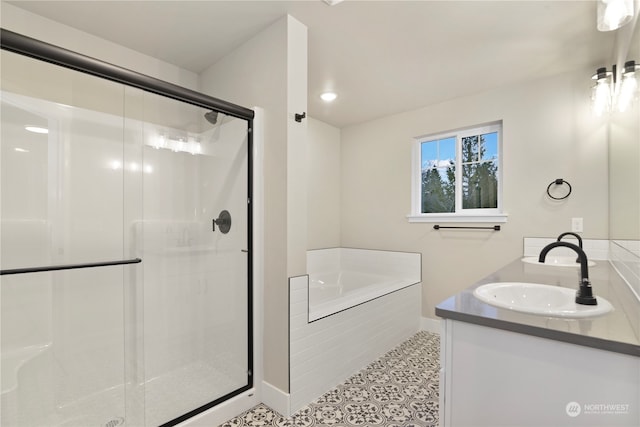 bathroom with tile patterned flooring, vanity, and independent shower and bath