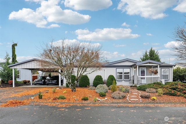 view of front of home featuring a carport and covered porch