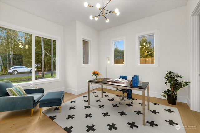 office featuring light hardwood / wood-style floors and a notable chandelier