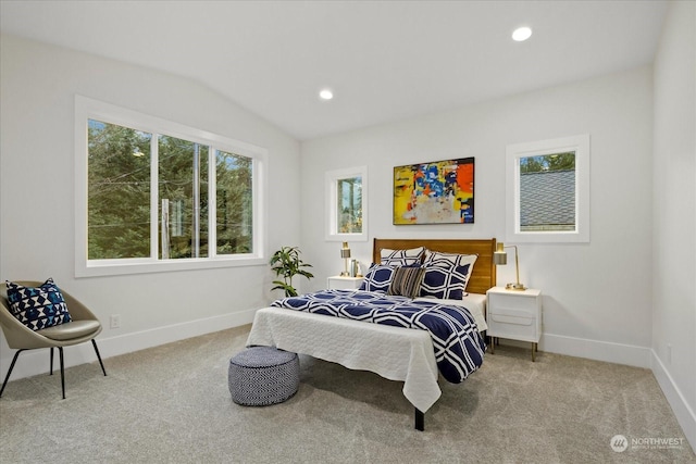 carpeted bedroom featuring lofted ceiling and multiple windows