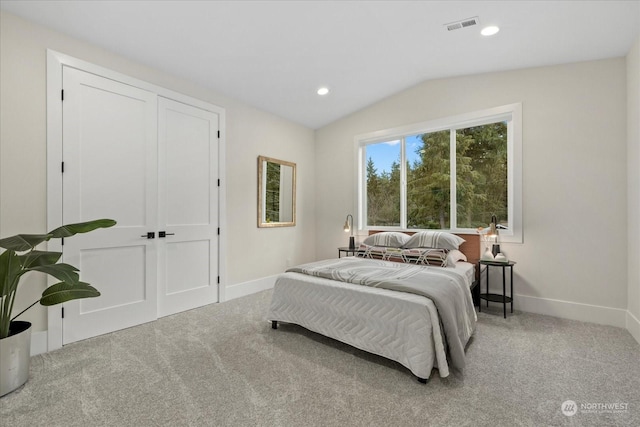 bedroom with light carpet and vaulted ceiling