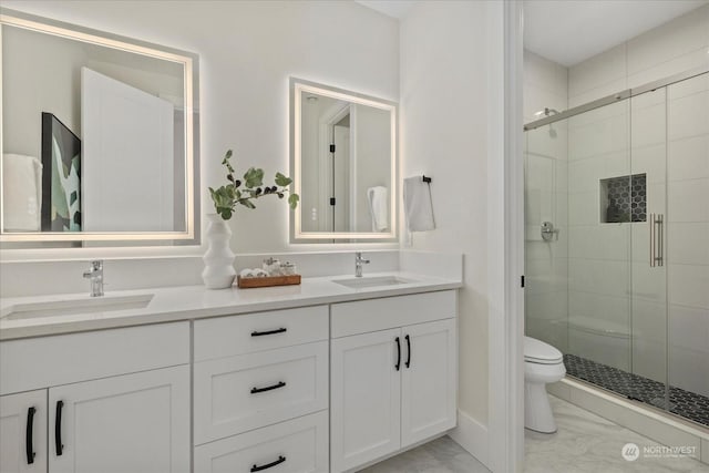 bathroom featuring walk in shower, vanity, and toilet