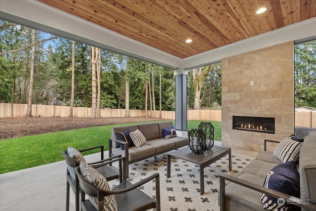 view of patio with an outdoor living space with a fireplace