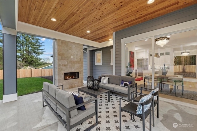 view of patio / terrace with an outdoor living space with a fireplace