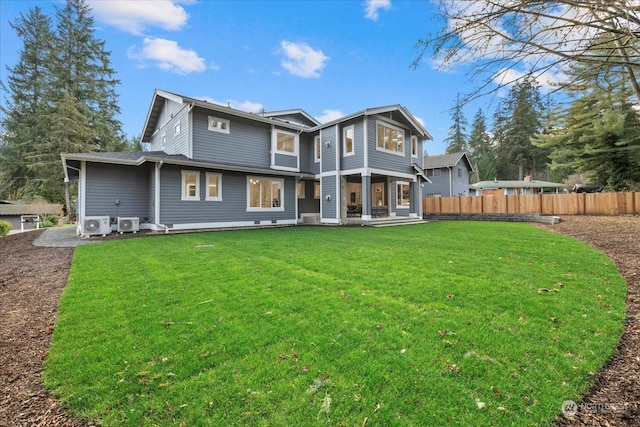 back of house featuring a lawn and ac unit