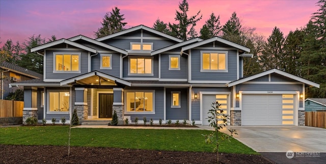 craftsman-style house with a yard and a garage