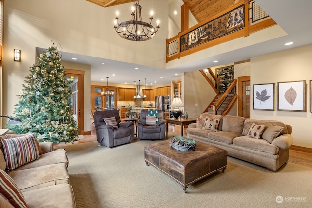 living room featuring light wood-type flooring, high vaulted ceiling, and a notable chandelier