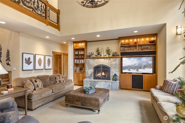 carpeted living room featuring a fireplace, a high ceiling, built in features, and recessed lighting