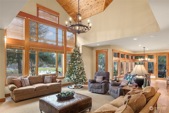 living room with wooden ceiling, an inviting chandelier, high vaulted ceiling, and light hardwood / wood-style floors