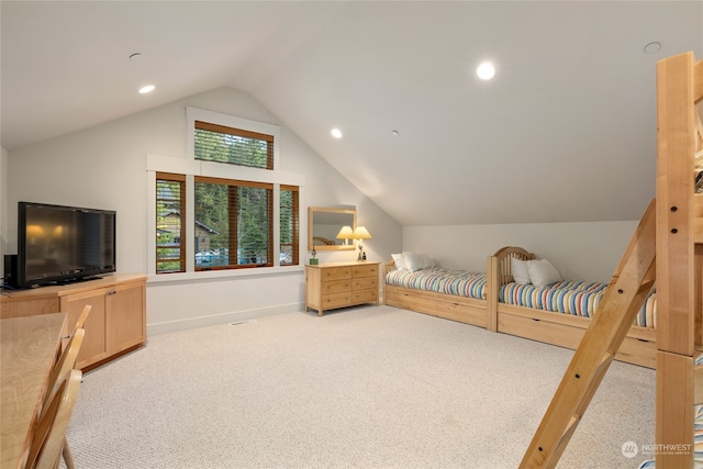 carpeted bedroom with vaulted ceiling