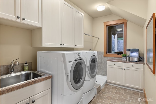 laundry area with cabinets, independent washer and dryer, and sink