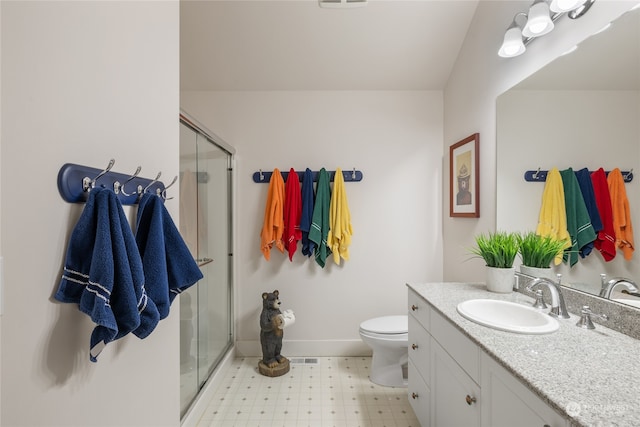 full bath with a stall shower, baseboards, toilet, tile patterned floors, and vanity