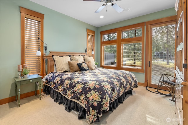 bedroom with access to outside, light carpet, and baseboards