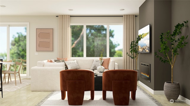 sitting room with heating unit and light hardwood / wood-style flooring