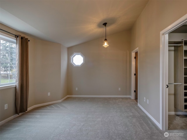 unfurnished room with carpet flooring and lofted ceiling