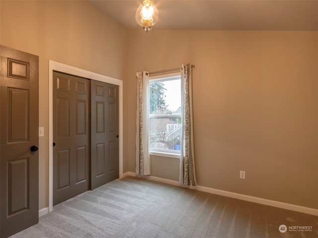 unfurnished bedroom with light carpet and a closet