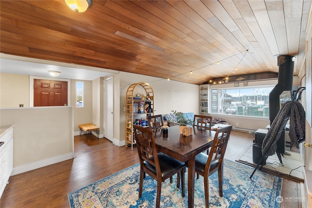 dining space featuring dark wood-type flooring, plenty of natural light, wooden ceiling, and vaulted ceiling