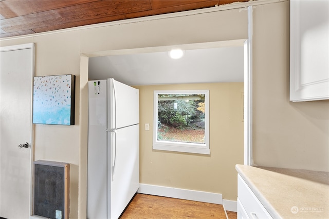 kitchen with light hardwood / wood-style flooring, white cabinets, lofted ceiling, and white refrigerator