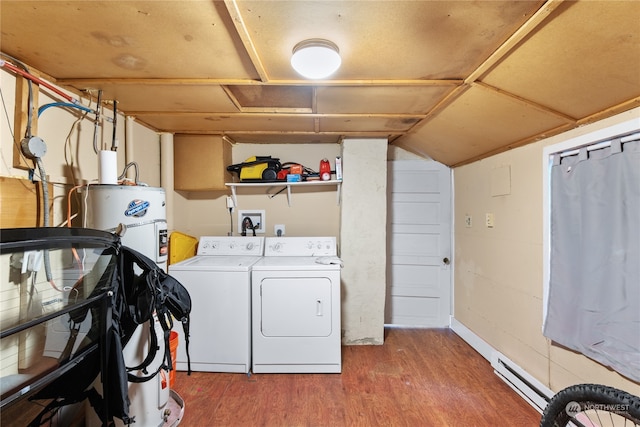 washroom featuring hardwood / wood-style floors, gas water heater, baseboard heating, and washing machine and clothes dryer