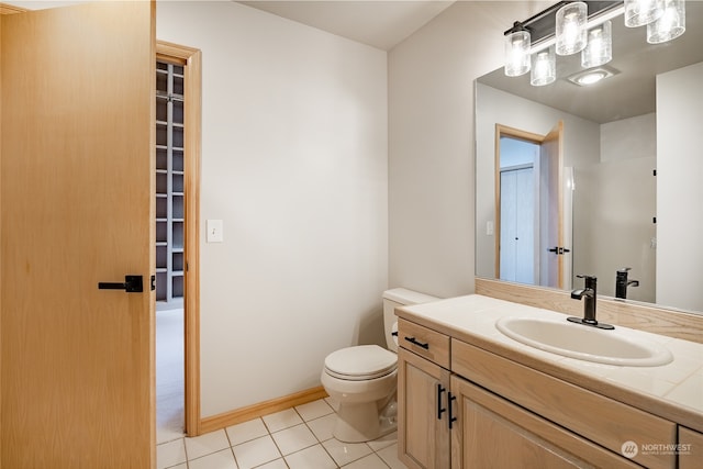 bathroom with toilet, vanity, tile patterned floors, and walk in shower