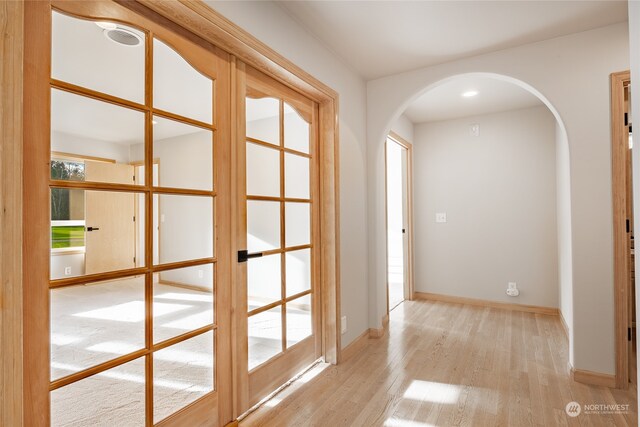 hallway with light hardwood / wood-style flooring