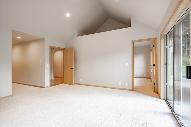 unfurnished room featuring carpet flooring and high vaulted ceiling