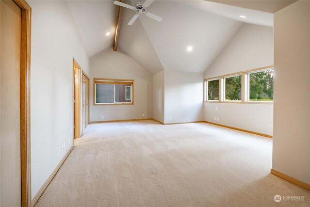 bonus room with lofted ceiling with beams, ceiling fan, and light colored carpet