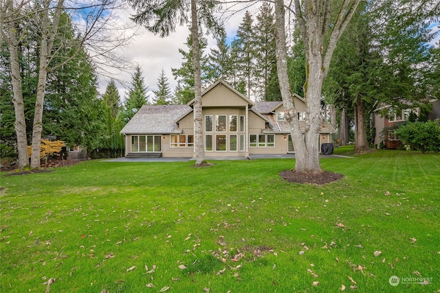 rear view of property featuring a yard