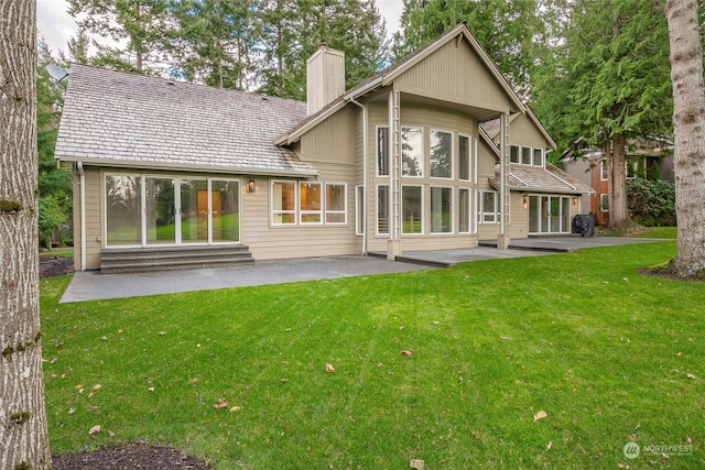 back of house featuring a yard and a patio