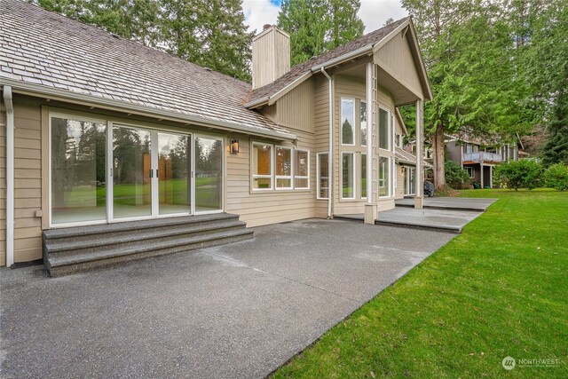 back of house featuring a lawn