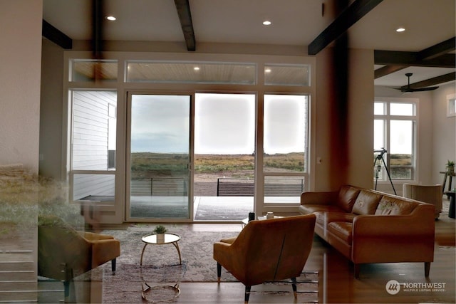 living room featuring beam ceiling, ceiling fan, and hardwood / wood-style floors