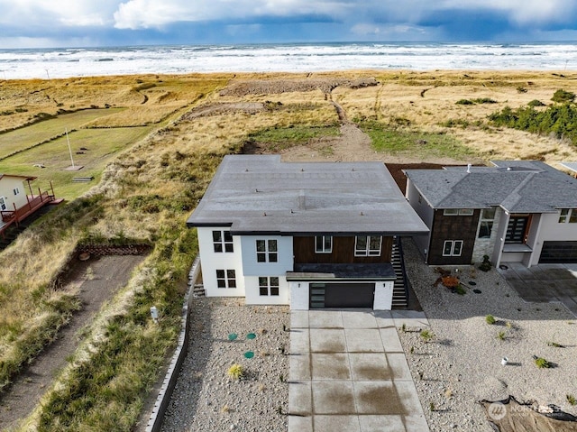 birds eye view of property with a view of the beach and a water view