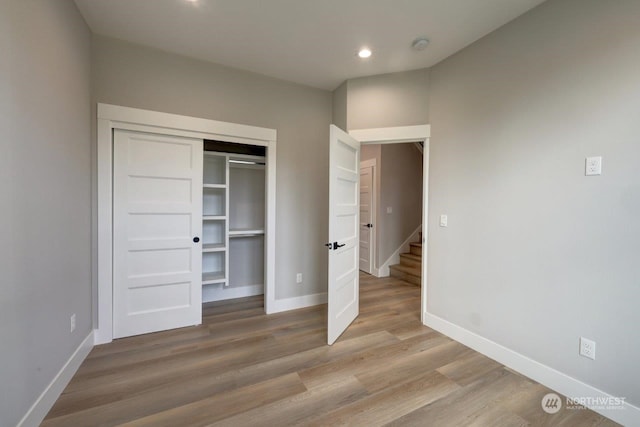 unfurnished bedroom featuring light wood-type flooring and a closet